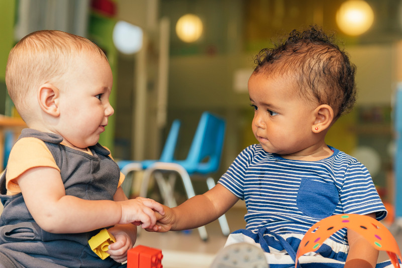 two babies looking at each other